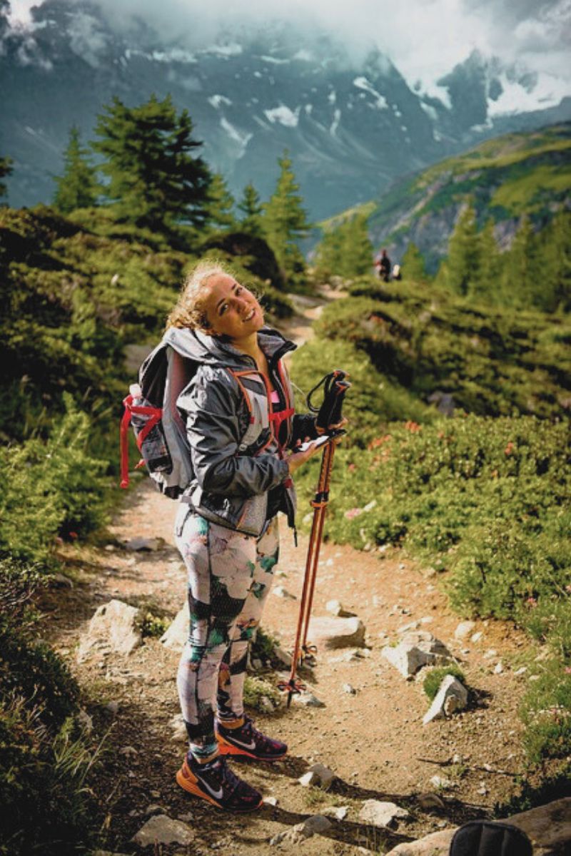Girl on a hiking trail smiling back